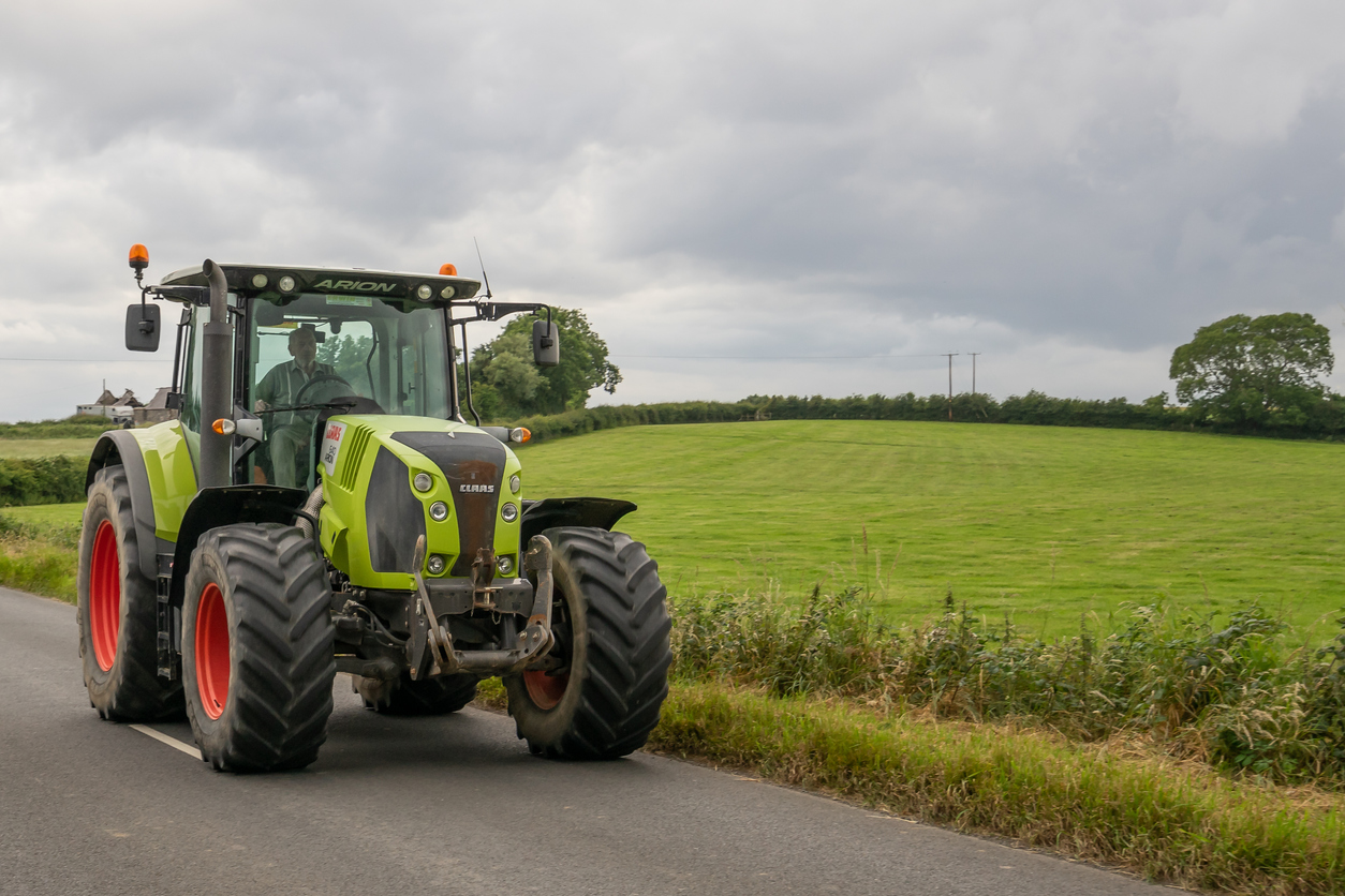 Green tractor beside field